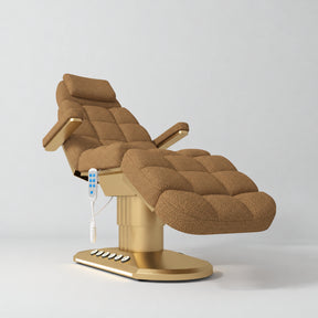 Manufakturo Orielle A Brown teddy electric beauty bed with gold oval base and current hand-held controller.