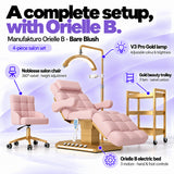 Manufakturo Orielle B Bare Blush four-piece salon set features: electric bed with three motors and hand and foot controls, height-adjustable Noblesse swivel chair, V3 Pro Gold lamp and three-tier gold trolley.