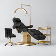 Manufakturo Orielle B Black four-piece beauty studio set with Noblesse chair, V3 Pro Gold treatment lamp, empty gold trolley and current hand control.
