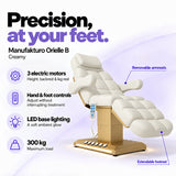 Manufakturo Orielle B Creamy electric beauty bed features: 3 motors, hand and foot controls, LED base lighting, 300 kg maximum load, removable armrests and extendable footrest.