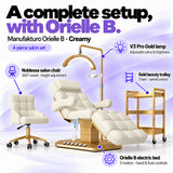 Manufakturo Orielle B Creamy four-piece salon set features: electric bed with three motors and hand and foot controls, height-adjustable Noblesse swivel chair, V3 Pro Gold lamp and three-tier gold trolley.