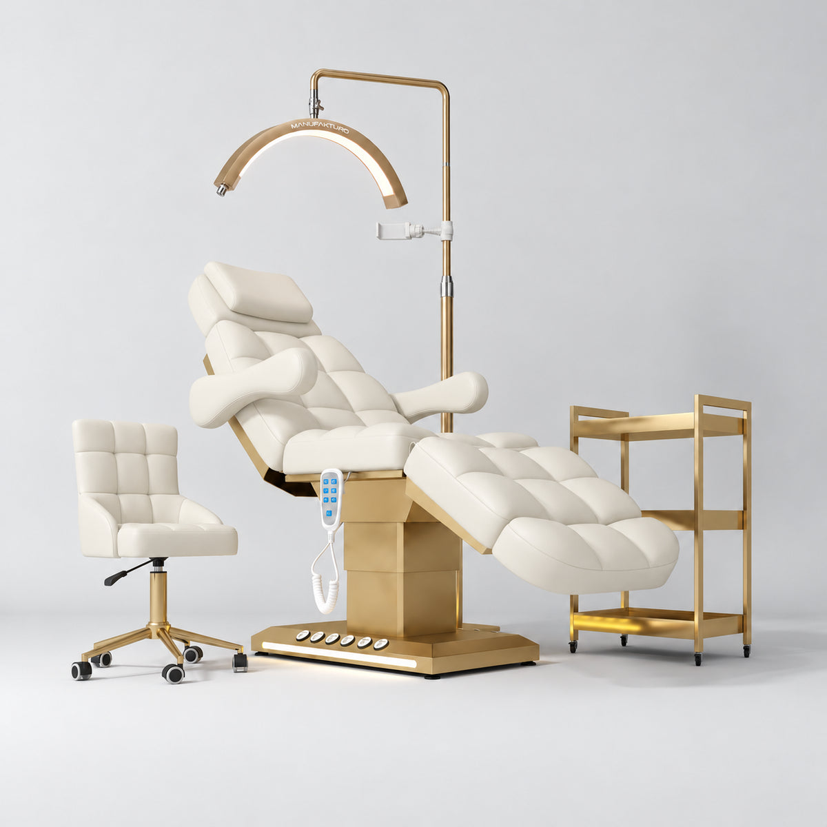 Manufakturo Orielle B Creamy four-piece beauty studio set with Noblesse chair, V3 Pro Gold treatment lamp, empty gold trolley and current hand control.