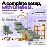 Manufakturo Orielle B Olive four-piece salon set features: electric bed with three motors and hand and foot controls, height-adjustable Noblesse swivel chair, V3 Pro Gold lamp and three-tier gold trolley.