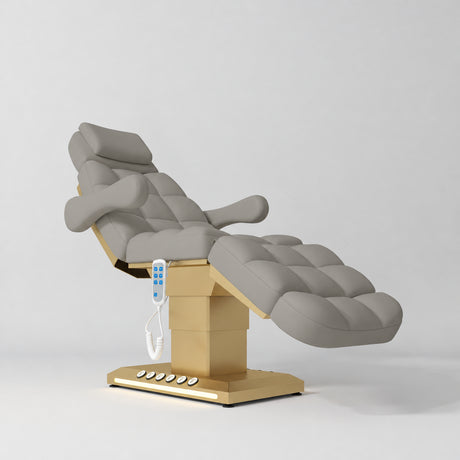 Manufakturo Orielle B Pearl Greige electric beauty bed with gold base and current hand-held controller.