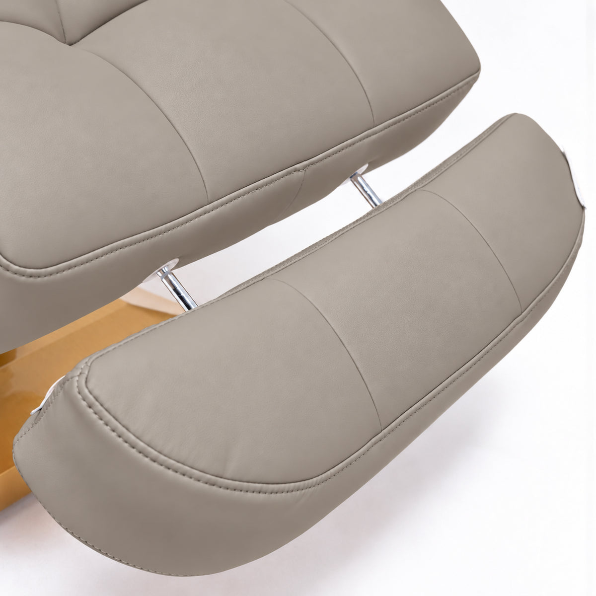 Manufakturo Orielle B Stone Taupe extendable footrest showing faux-leather upholstery, stitching and chrome extension rods.
