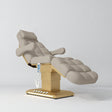 Manufakturo Orielle B Stone Taupe electric beauty bed with gold base and current hand-held controller.