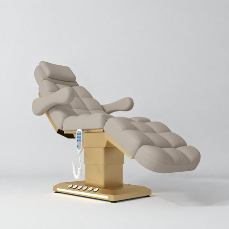 Manufakturo Orielle B Stone Taupe electric beauty bed with gold base and current hand-held controller.