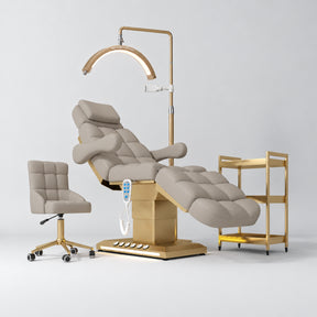 Manufakturo Orielle B Stone Taupe four-piece beauty studio set with Noblesse chair, V3 Pro Gold treatment lamp, empty gold trolley and current hand control.