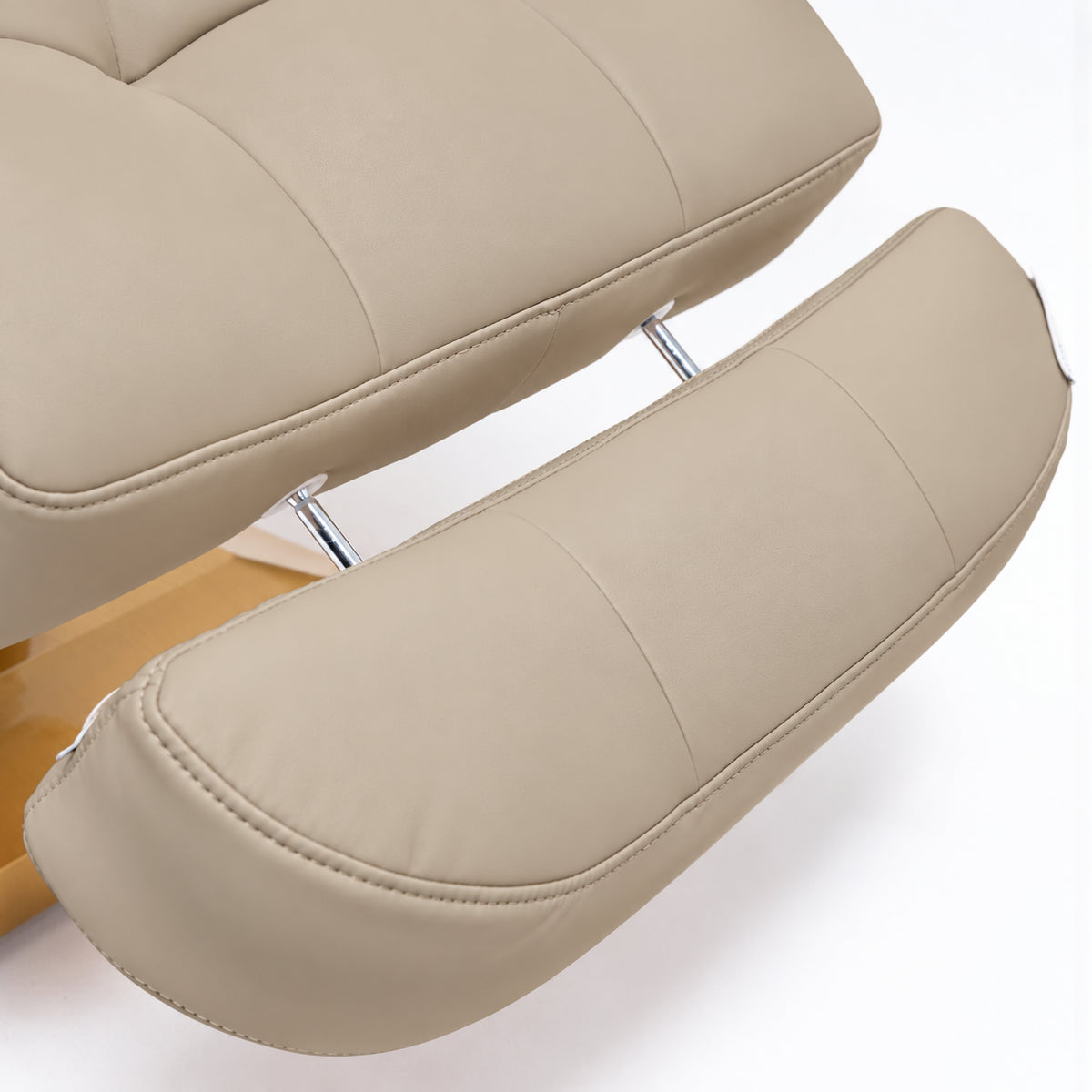 Manufakturo Orielle B Warm Beige extendable footrest showing faux-leather upholstery, stitching and chrome extension rods.