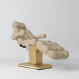 Manufakturo Orielle B Warm Beige electric beauty bed with gold base and current hand-held controller.