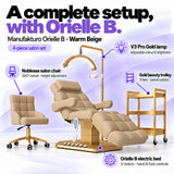 Manufakturo Orielle B Warm Beige four-piece salon set features: electric bed with three motors and hand and foot controls, height-adjustable Noblesse swivel chair, V3 Pro Gold lamp and three-tier gold trolley.