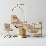Manufakturo Orielle B Warm Beige four-piece beauty studio set with Noblesse chair, V3 Pro Gold treatment lamp, empty gold trolley and current hand control.