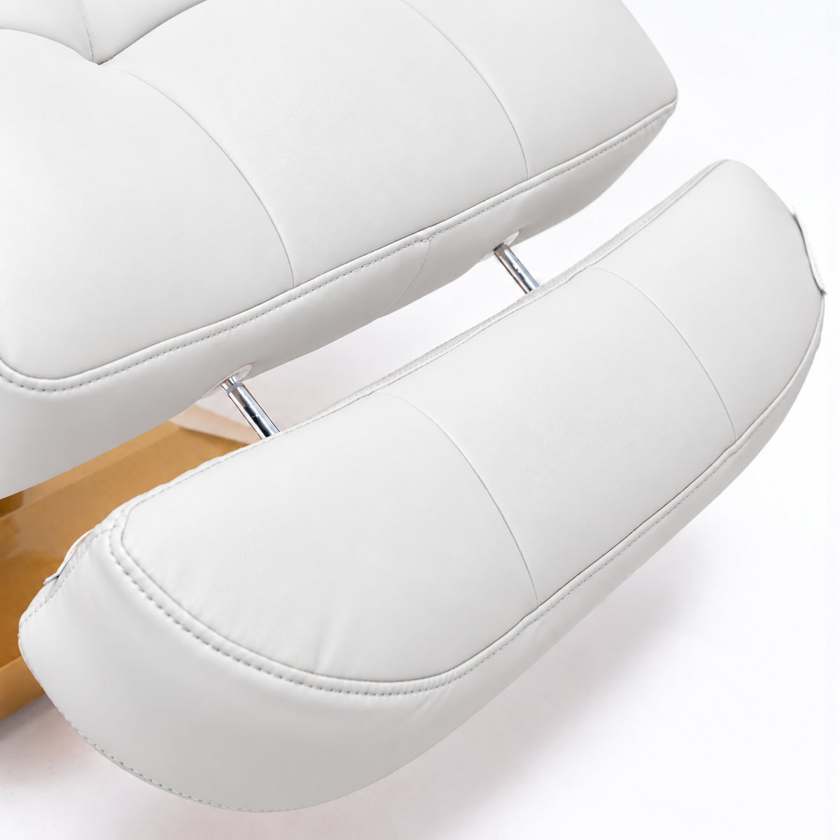 Manufakturo Orielle B White extendable footrest showing faux-leather upholstery, stitching and chrome extension rods.