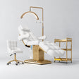 Manufakturo Orielle B White four-piece beauty studio set with Noblesse chair, V3 Pro Gold treatment lamp, empty gold trolley and current hand control.