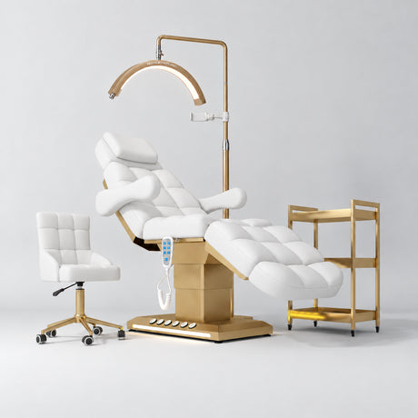 Manufakturo Orielle B White four-piece beauty studio set with Noblesse chair, V3 Pro Gold treatment lamp, empty gold trolley and current hand control.