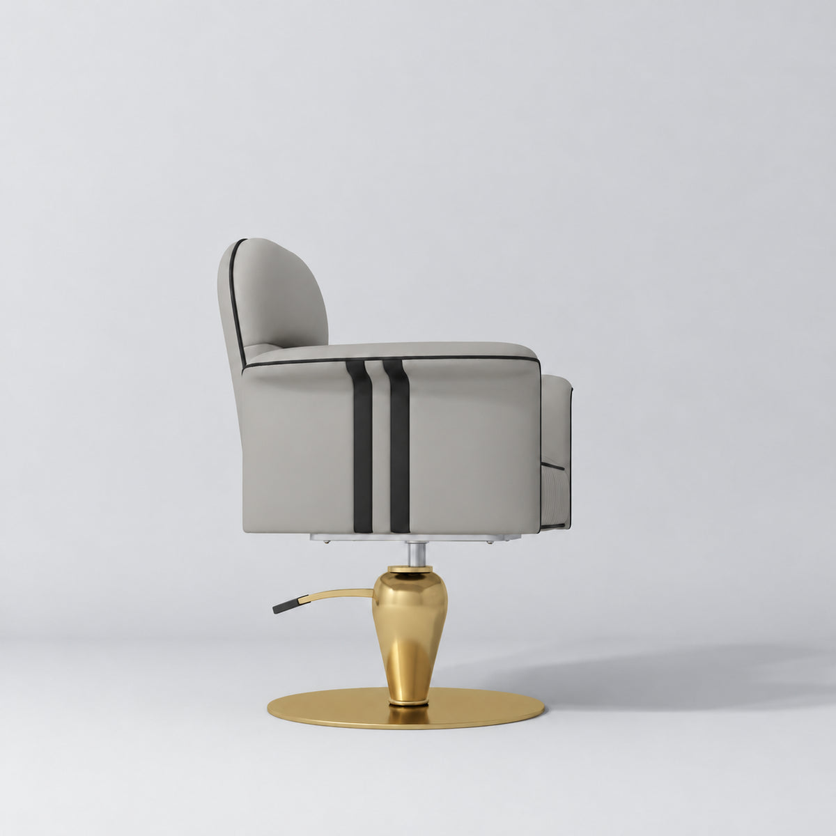 Side view of the Manufakturo Palais styling chair in Pearl Greige with black piping and a gold pedestal base, on a grey studio background.