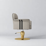 Side view of the Manufakturo Palais styling chair in Stone Taupe with black piping and a gold pedestal base, on a grey studio background.