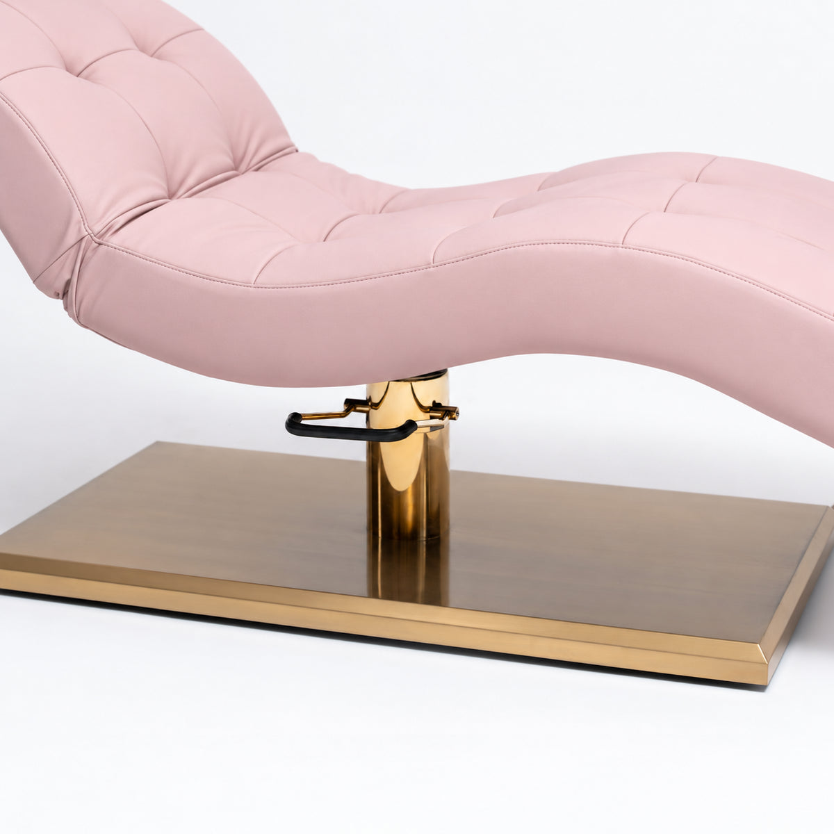 Manufakturo Prestige Bare Blush upholstered bed close-up with gold hydraulic pump, black foot pedal and rectangular gold base.