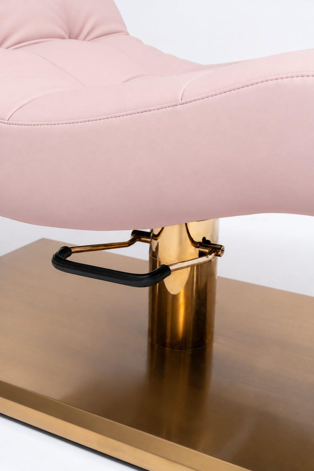 Manufakturo Prestige Bare Blush close-up of upholstered stitching, gold hydraulic column and black foot pedal.