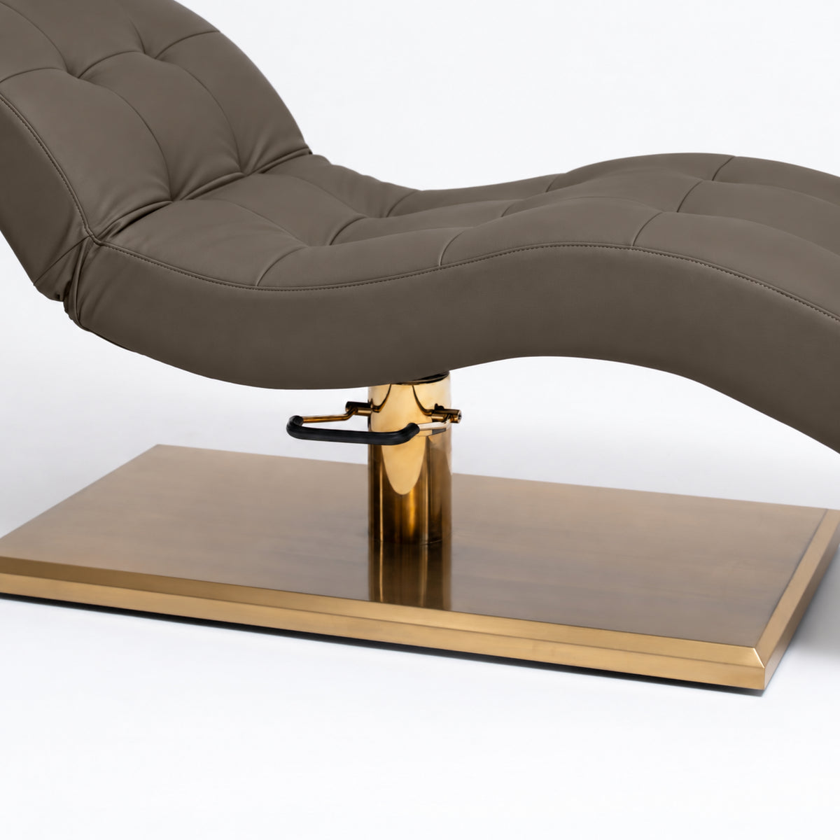 Manufakturo Prestige Cocoa Mocha upholstered bed close-up with gold hydraulic pump, black foot pedal and rectangular gold base.