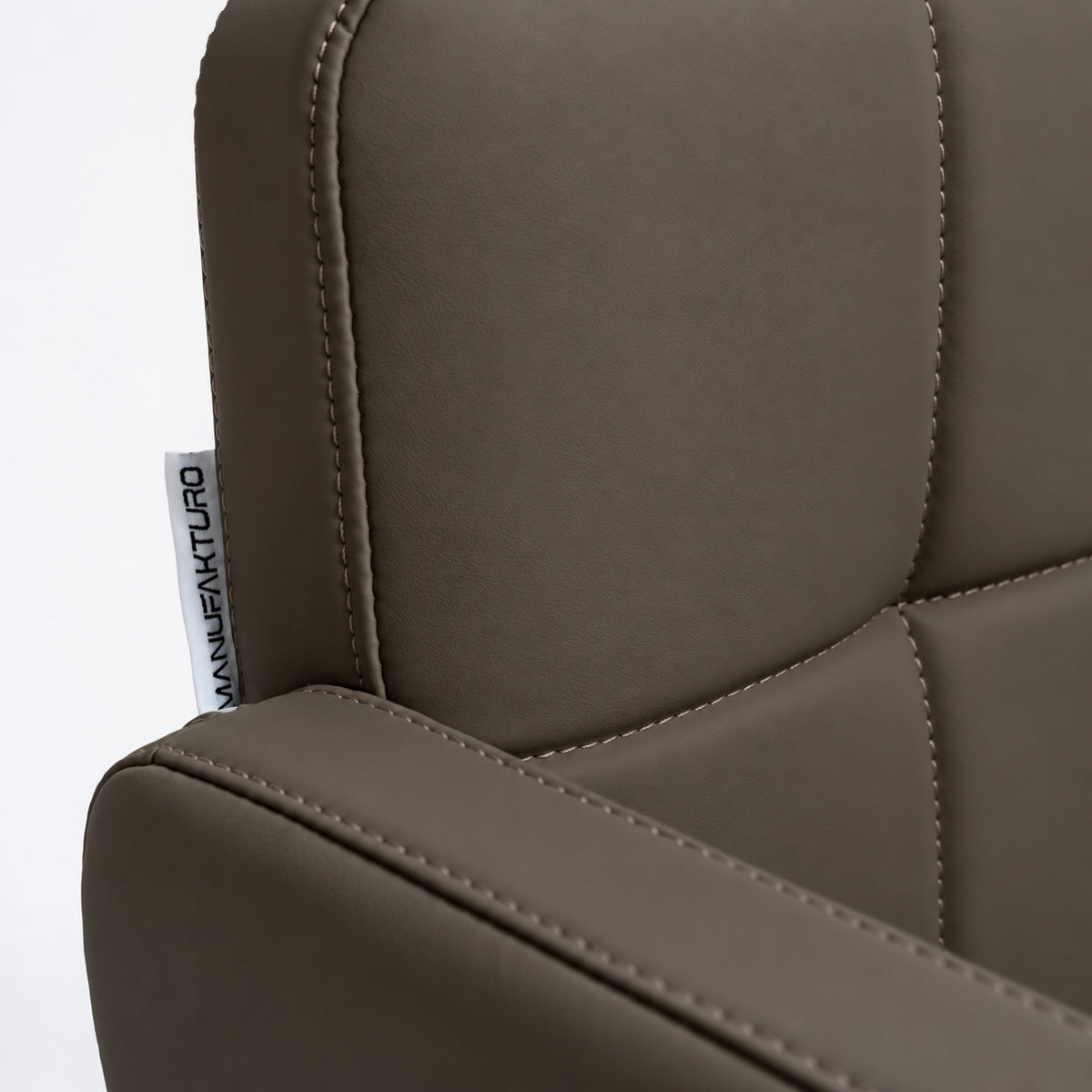 Manufakturo Serenity Cocoa Mocha salon chair close-up of the padded armrest, backrest and upholstery stitching.
