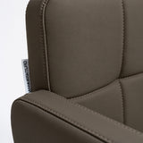 Manufakturo Serenity Cocoa Mocha salon chair close-up of the padded armrest, backrest and upholstery stitching.