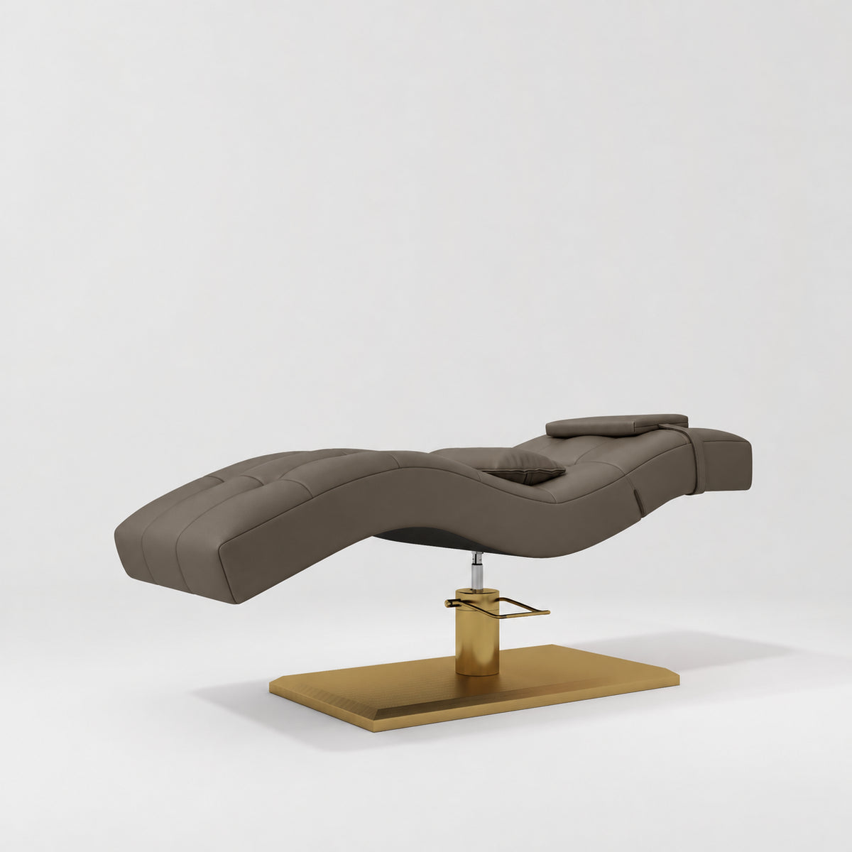 Manufakturo Prestige Cocoa Mocha hydraulic eyelash bed, three-quarter side view with gold pedestal base and contoured upholstery.