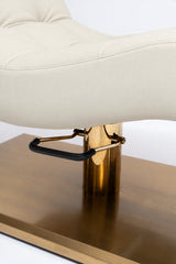 Manufakturo Prestige Creamy close-up of upholstered stitching, gold hydraulic column and black foot pedal.