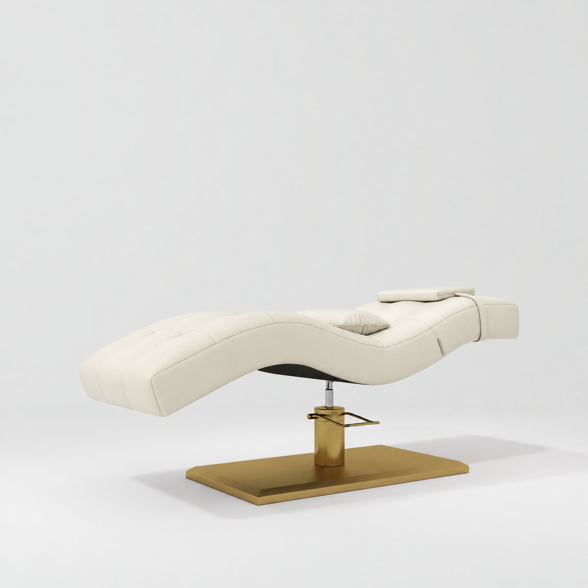 Manufakturo Prestige Creamy hydraulic eyelash bed, three-quarter side view with gold pedestal base and contoured upholstery.