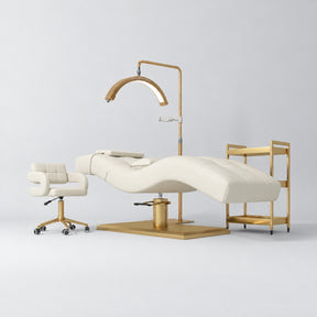 Manufakturo Prestige Creamy studio set with hydraulic lash bed, Serenity chair, V3 Pro Gold lamp and empty gold trolley.