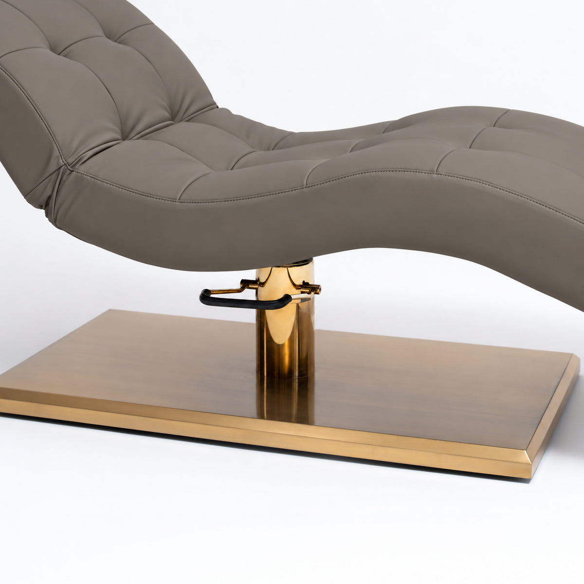 Manufakturo Prestige Deep Ash upholstered bed close-up with gold hydraulic pump, black foot pedal and rectangular gold base.