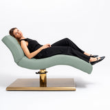 Manufakturo Prestige Olive hydraulic beauty bed with a reclining client, showing contoured upholstery and gold base.