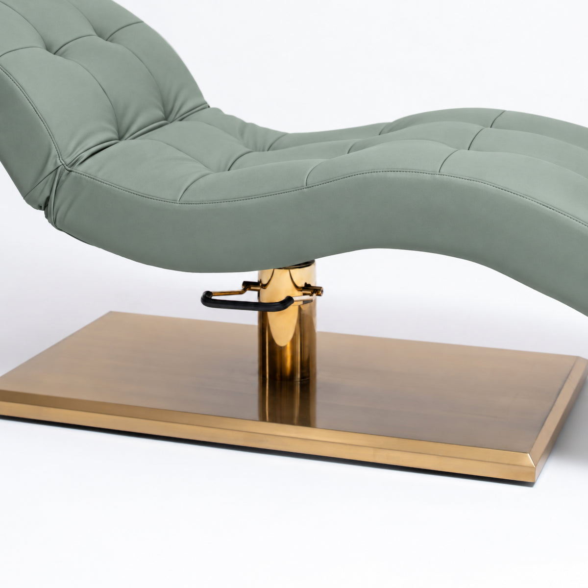 Manufakturo Prestige Olive upholstered bed close-up with gold hydraulic pump, black foot pedal and rectangular gold base.