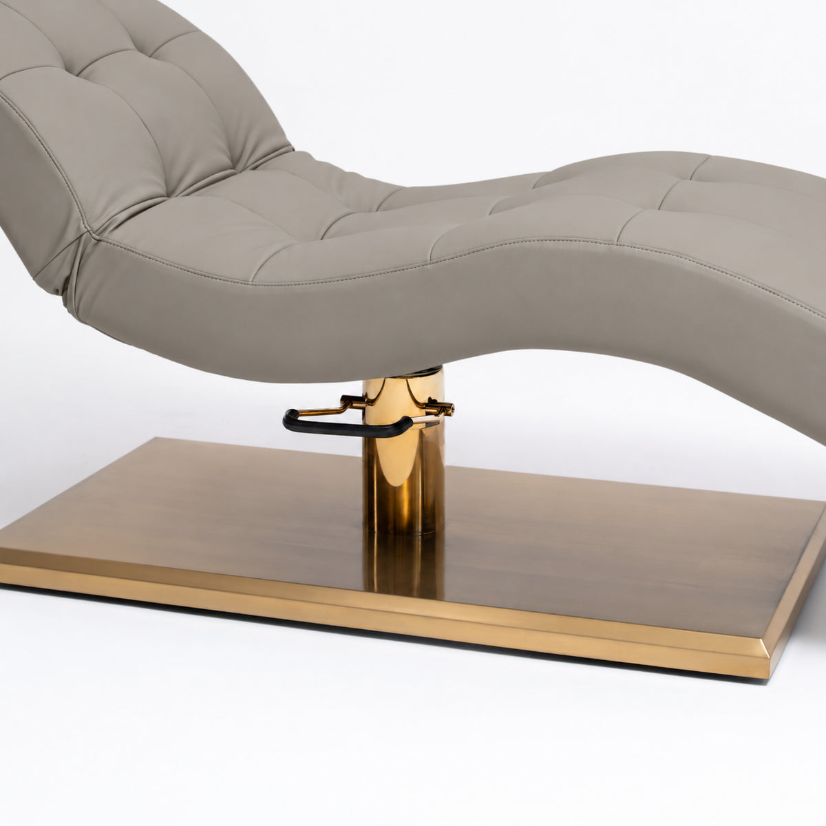 Manufakturo Prestige Pearl Greige upholstered bed close-up with gold hydraulic pump, black foot pedal and rectangular gold base.