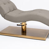 Manufakturo Prestige Pearl Greige upholstered bed close-up with gold hydraulic pump, black foot pedal and rectangular gold base.