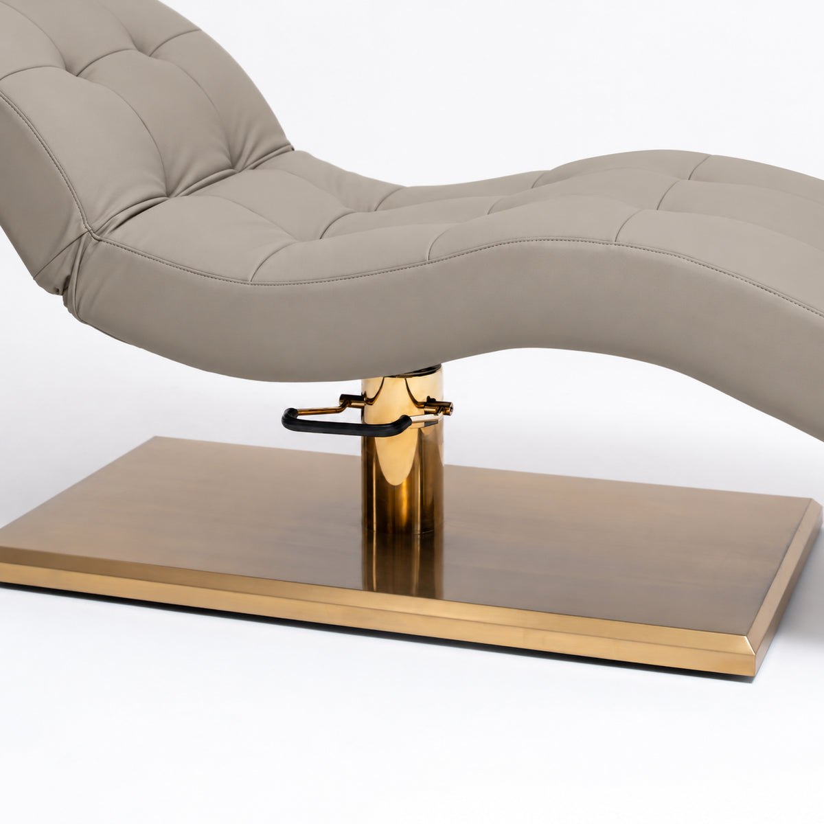 Manufakturo Prestige Stone Taupe upholstered bed close-up with gold hydraulic pump, black foot pedal and rectangular gold base.