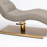 Manufakturo Prestige Stone Taupe upholstered bed close-up with gold hydraulic pump, black foot pedal and rectangular gold base.