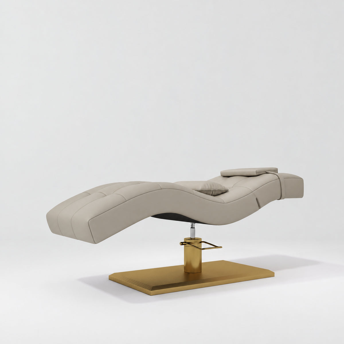 Manufakturo Prestige Stone Taupe hydraulic eyelash bed, three-quarter side view with gold pedestal base and contoured upholstery.