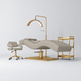 Manufakturo Prestige Stone Taupe studio set with hydraulic lash bed, Serenity chair, V3 Pro Gold lamp and empty gold trolley.