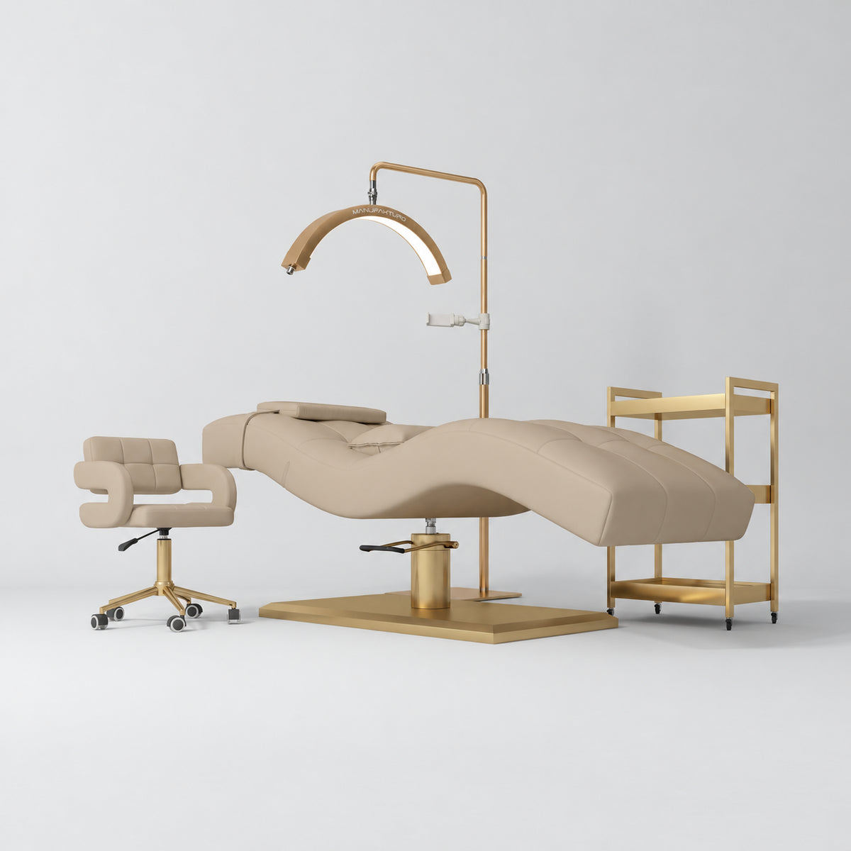 Manufakturo Prestige Warm Beige studio set with hydraulic lash bed, Serenity chair, V3 Pro Gold lamp and empty gold trolley.