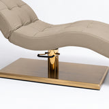 Manufakturo Prestige Warm Beige upholstered beauty bed close-up with gold hydraulic pump, black foot pedal and rectangular gold base.
