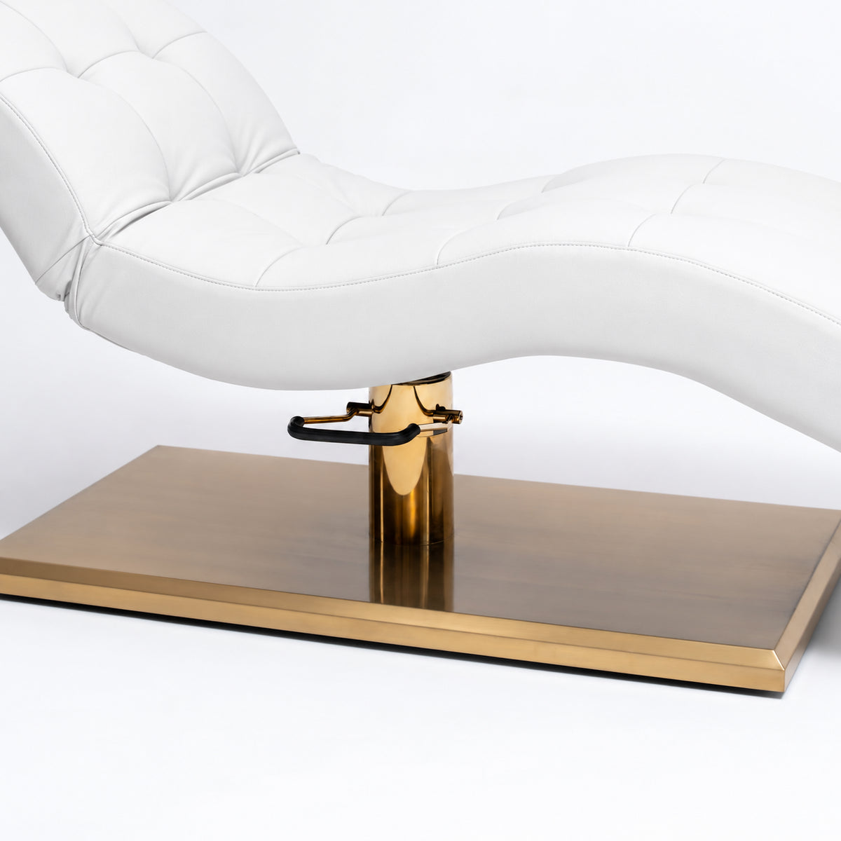 Manufakturo Prestige White upholstered bed close-up with gold hydraulic pump, black foot pedal and rectangular gold base.