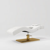 Manufakturo Prestige White hydraulic eyelash bed, three-quarter side view with gold pedestal base and contoured upholstery.