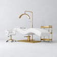 Manufakturo Prestige White studio set with hydraulic lash bed, Serenity chair, V3 Pro Gold lamp and empty gold trolley.