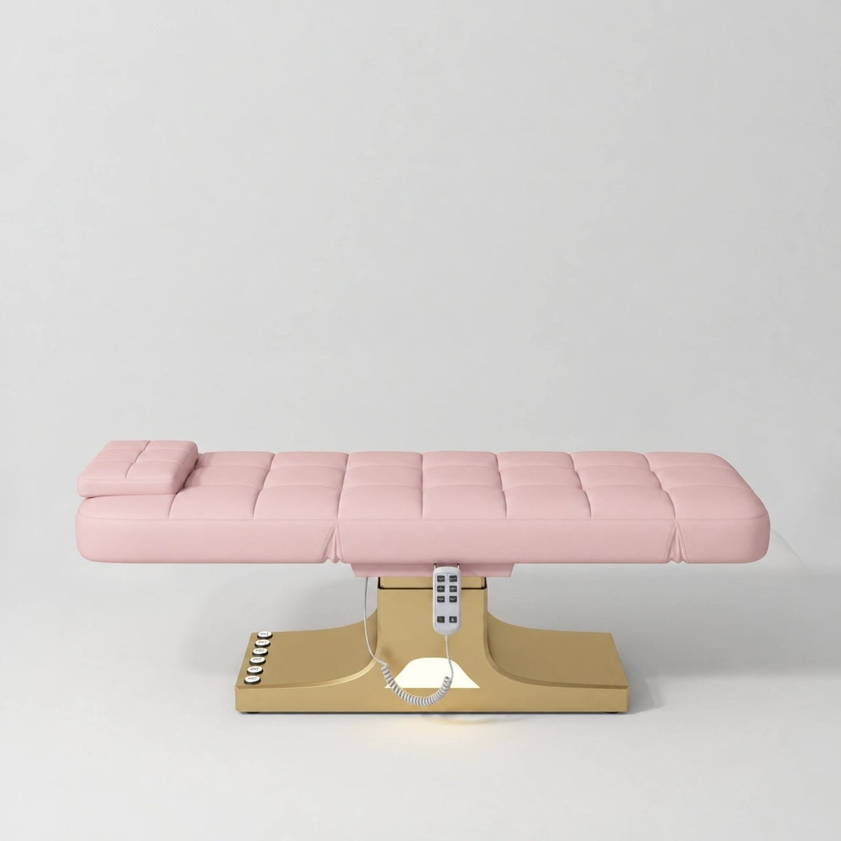 Manufakturo Saphir A Bare Blush electric beauty bed with gold base, flat lying position shown from the side, without armrests.