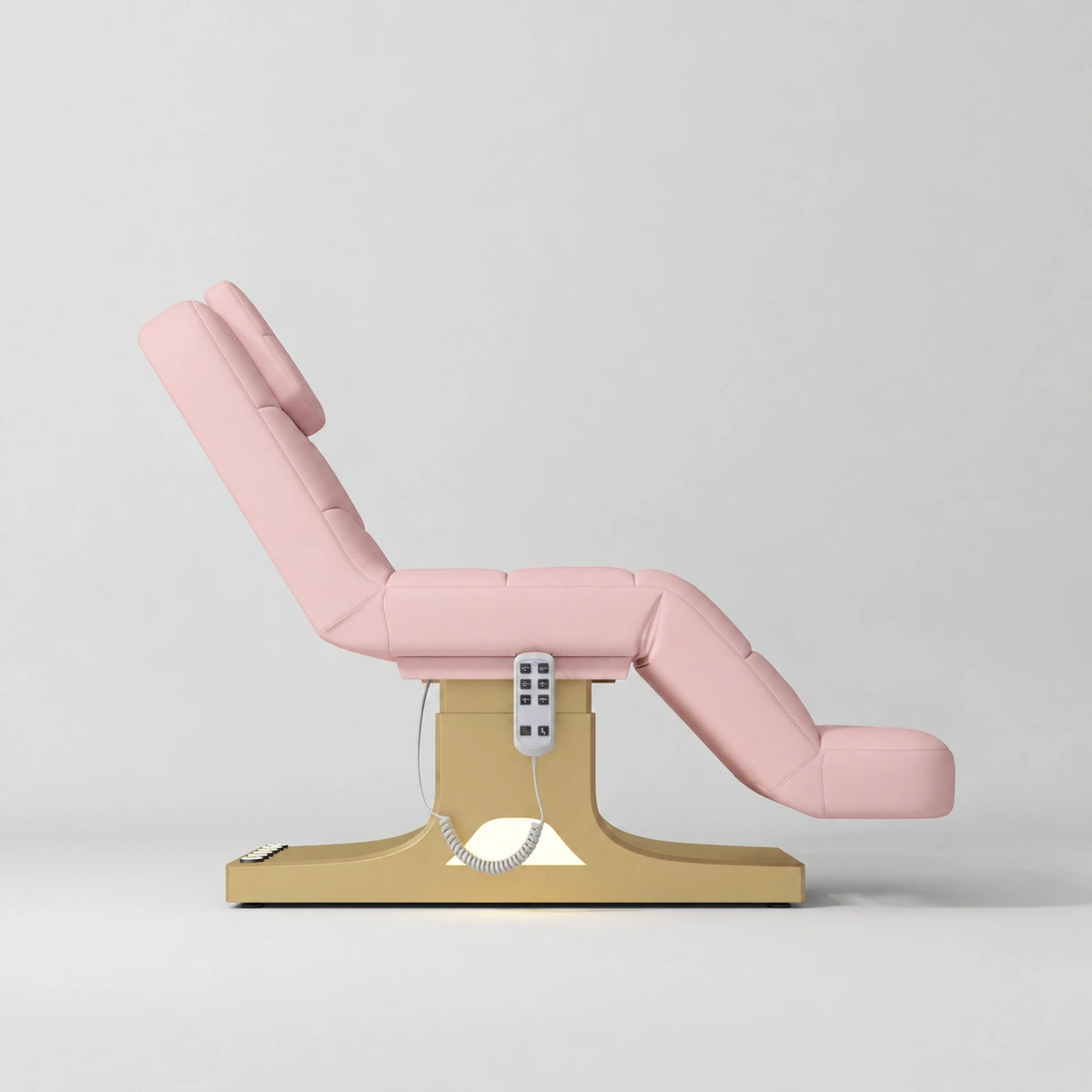 Manufakturo Saphir A Bare Blush electric beauty bed with gold base, raised treatment position shown from the side, without armrests.