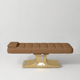 Manufakturo Saphir A Caramel electric beauty bed with gold base, flat lying position shown from the side, without armrests.