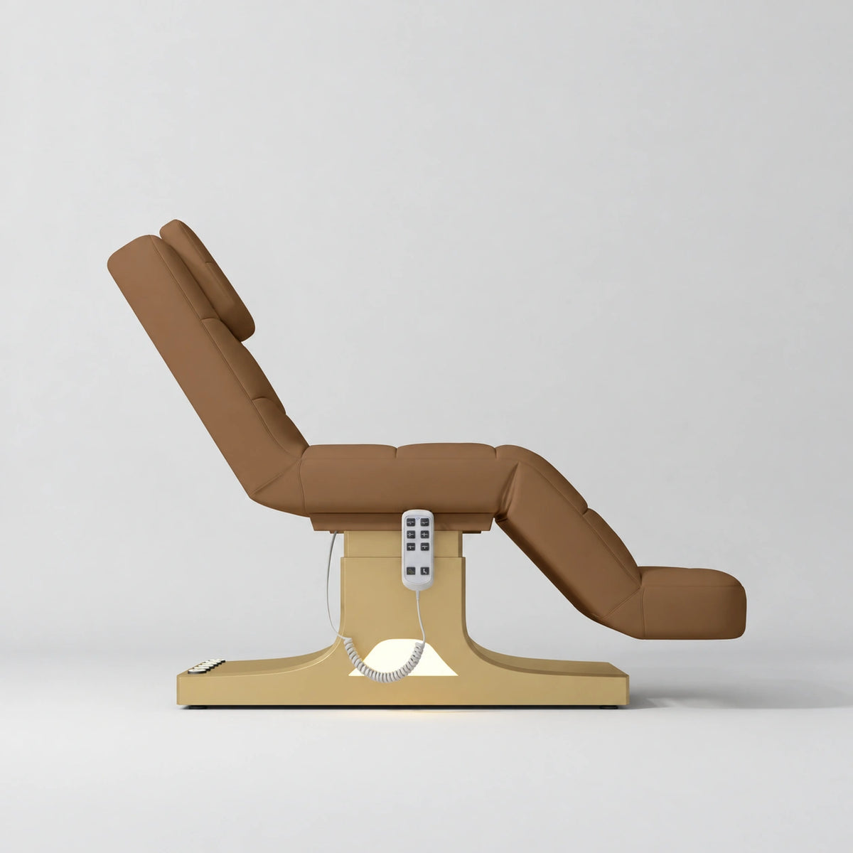 Manufakturo Saphir A Caramel electric beauty bed with gold base, raised treatment position shown from the side, without armrests.
