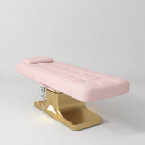 Manufakturo Saphir A Light Pink electric beauty bed with gold base, flat lying position shown in a three-quarter view, without armrests.