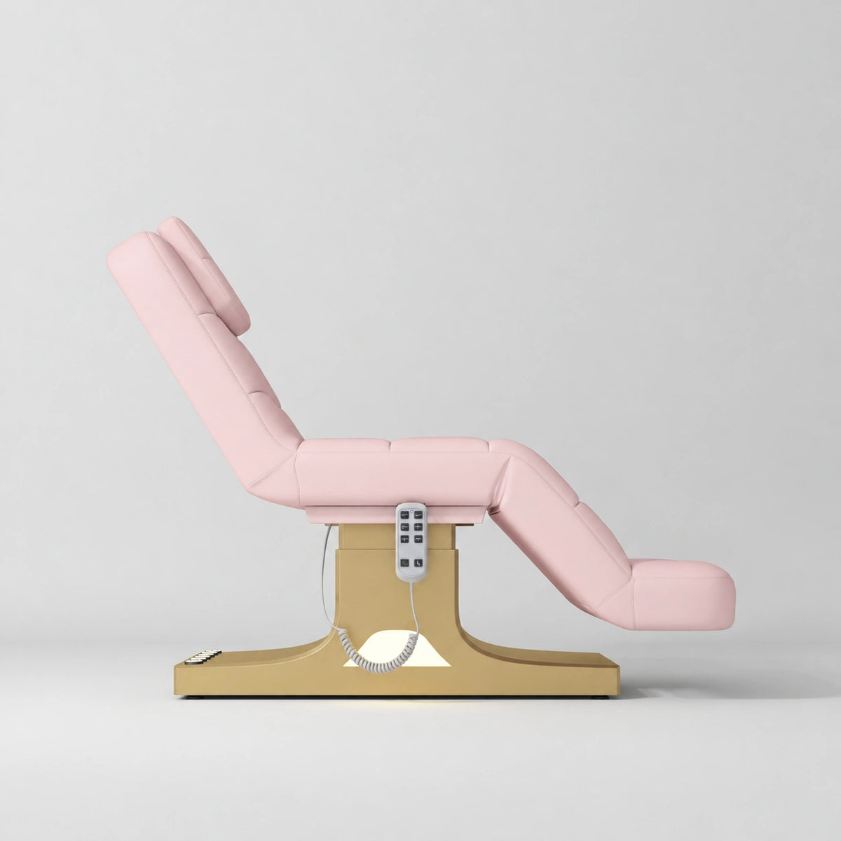Manufakturo Saphir A Light Pink electric beauty bed with gold base, raised treatment position shown from the side, without armrests.
